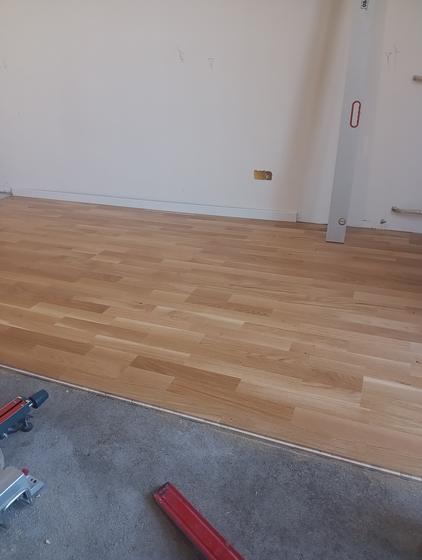 Half the room laid, the board joints staggered from one row to the next