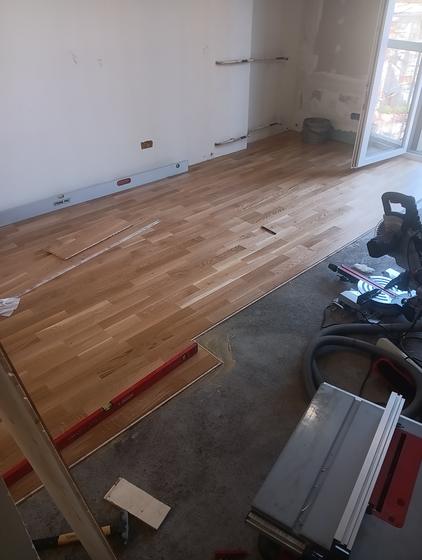 The run moves on toward the balcony door, the subfloor still showing
