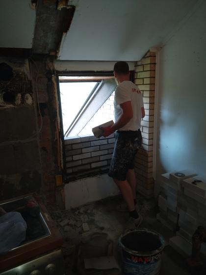Bricking up the opening, the first courses set into the window reveal